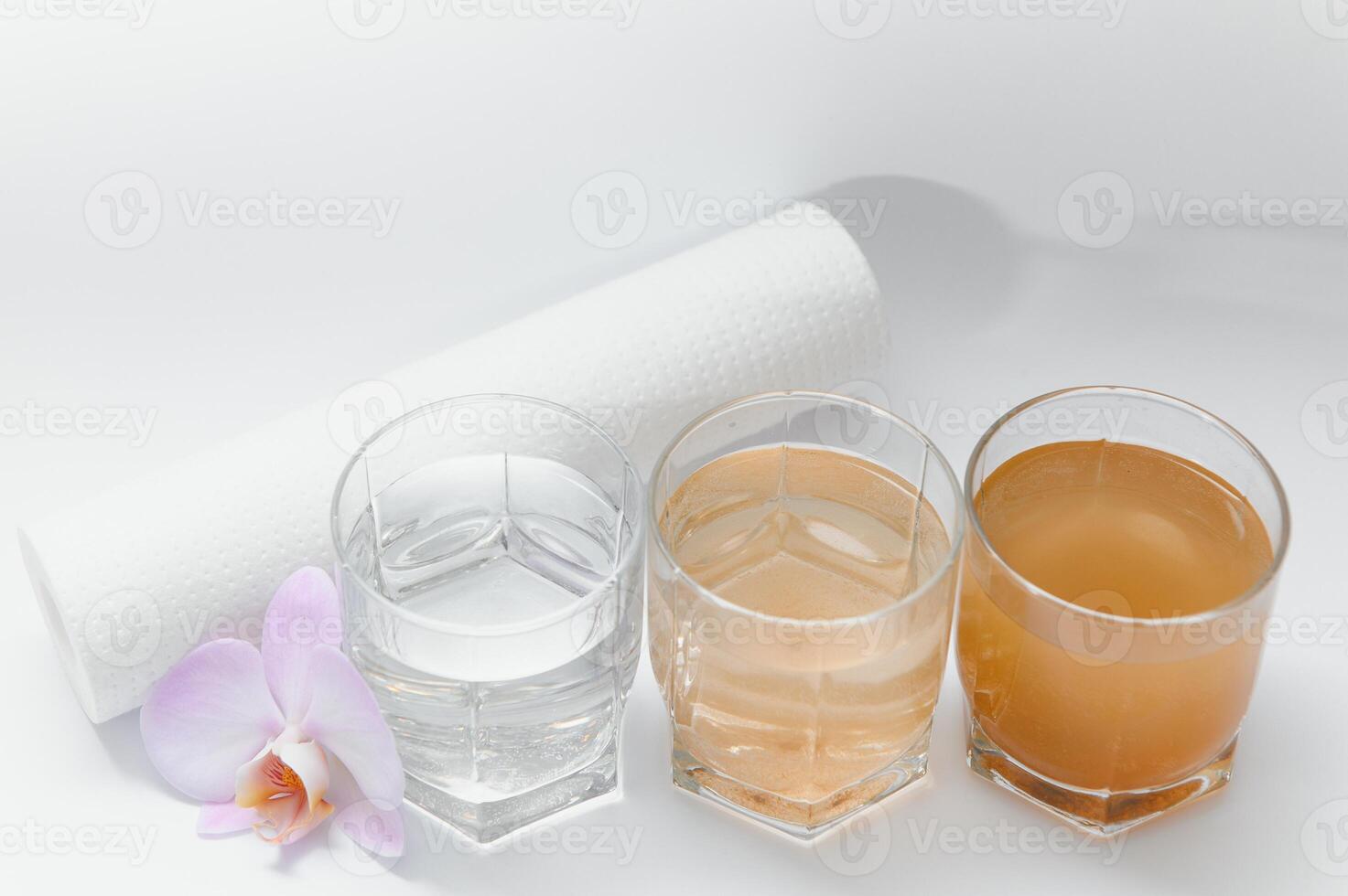 Water filters. Concept of three glasses on a white background. Household filtration system. photo
