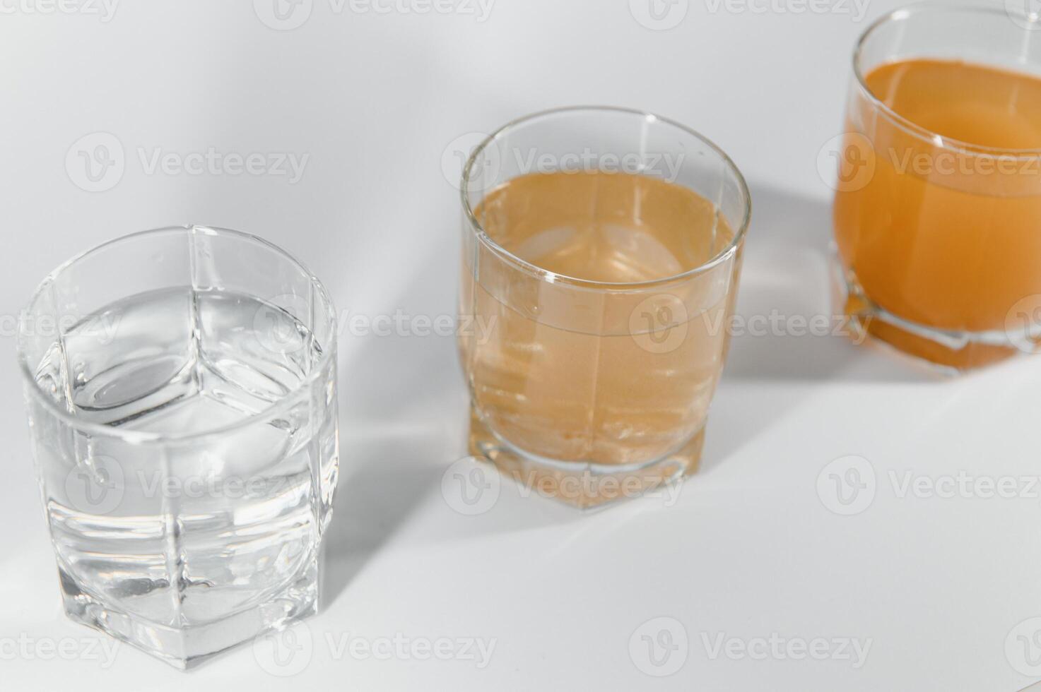 Water filters. Concept of three glasses on a white background. Household filtration system. photo