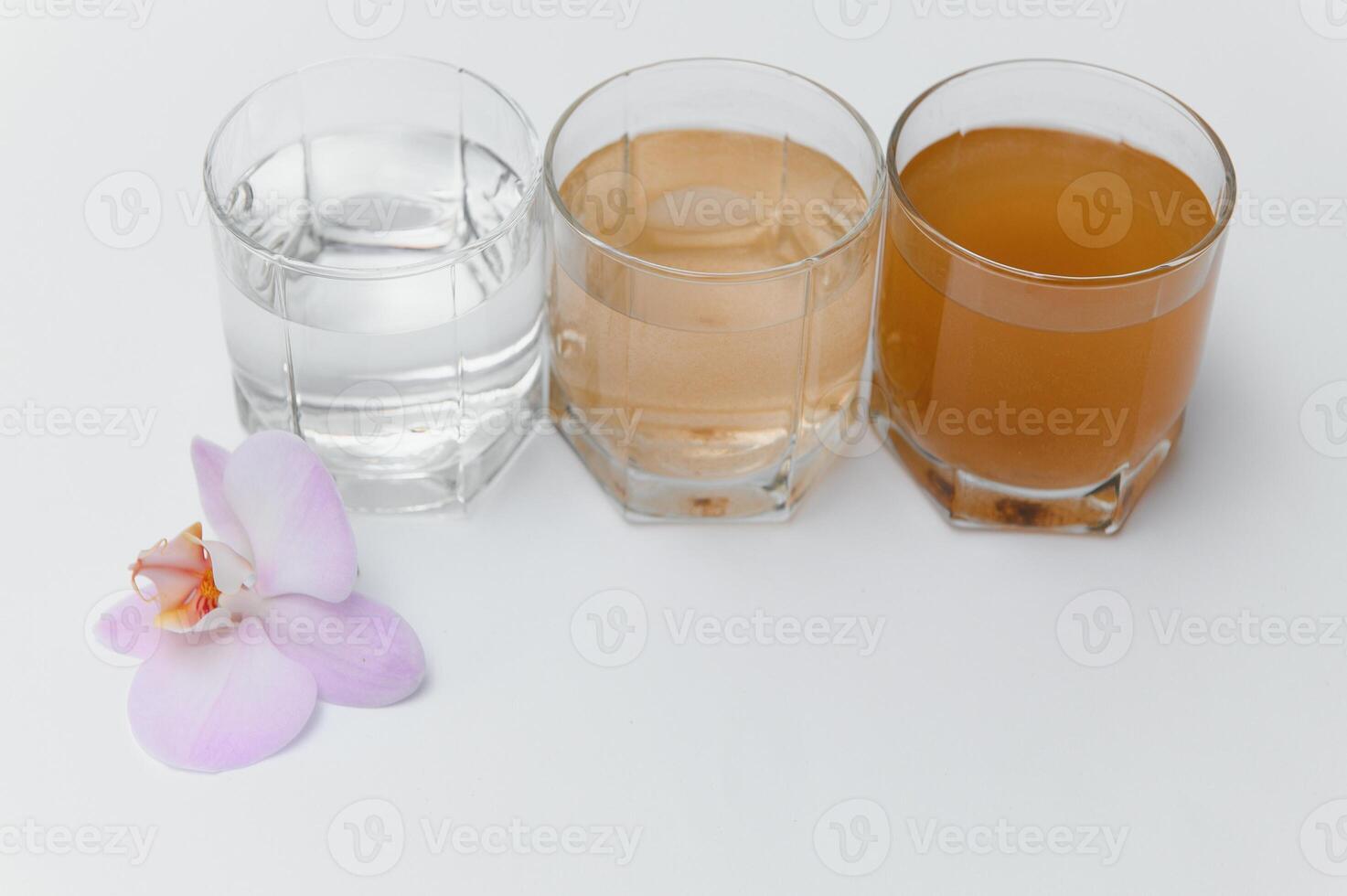 Filter system for water treatment with glasses of clean and dirty water on bright background photo