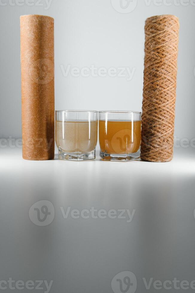 used water filters, glasses with dirty water photo