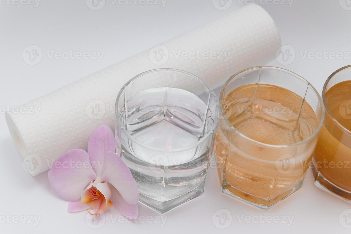 Water filters. Concept of three glasses on a white background. Household filtration system. photo