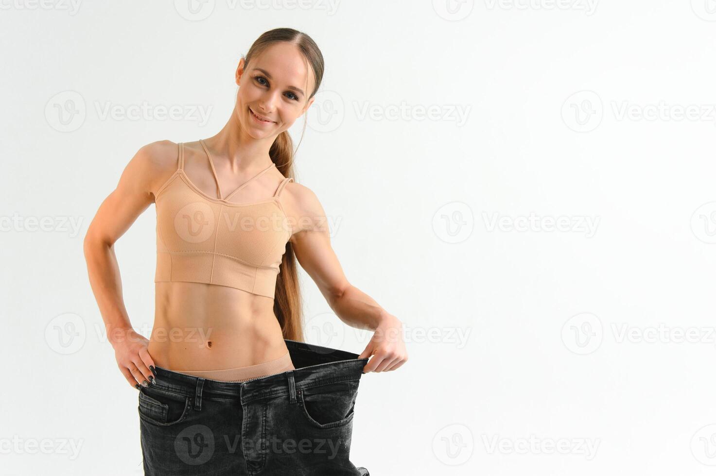 Happy girl showing her slim figure after workout photo