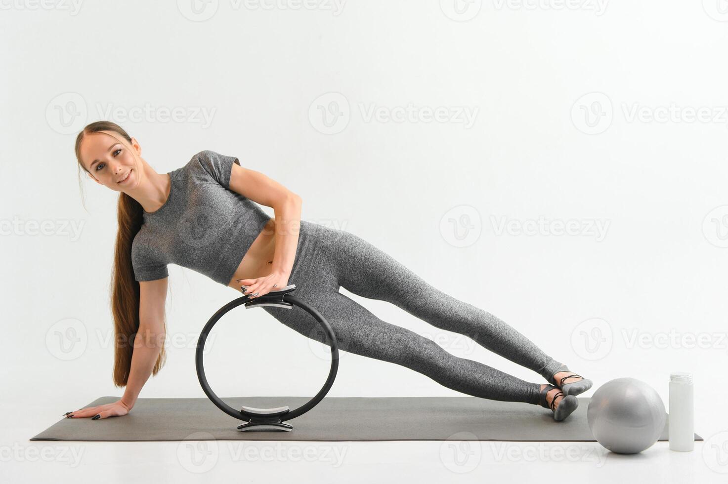 Young beautiful girl wearing fashion sports wear doing exercise photo
