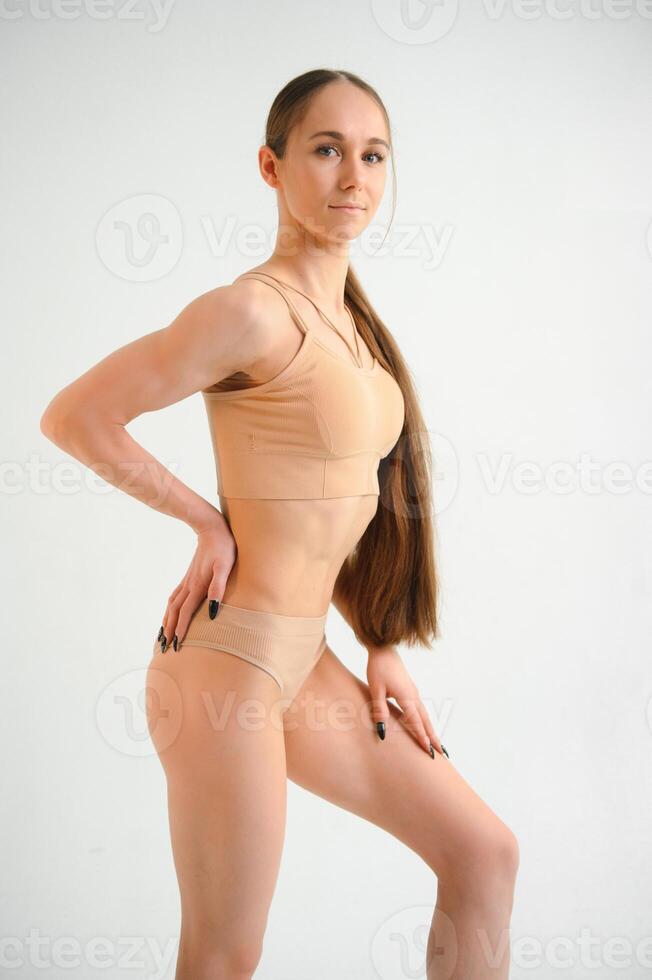 Beautiful woman with slim body in underwear is in the studio. photo