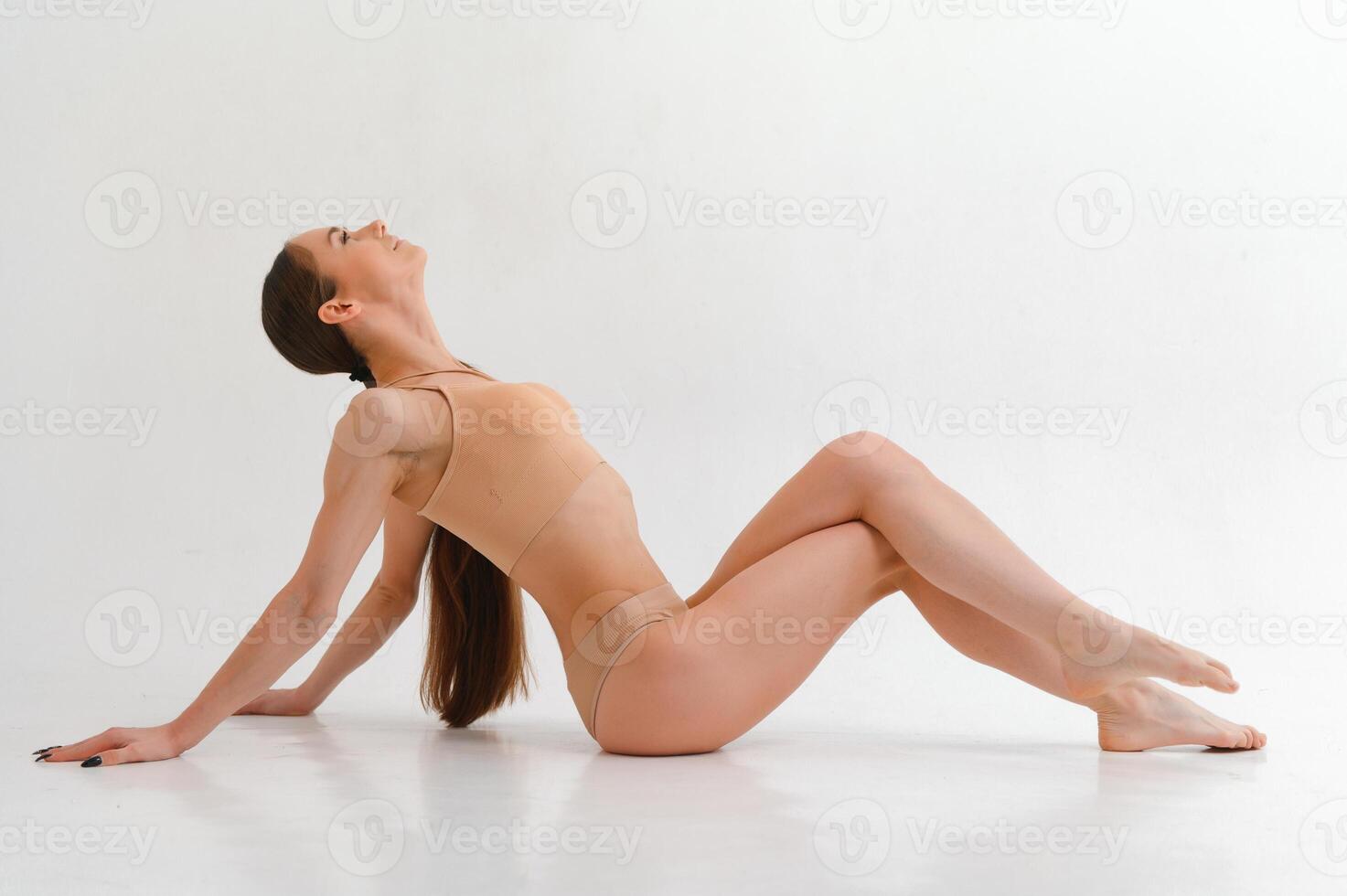 The body of a young athletic girl isolated on a white background photo