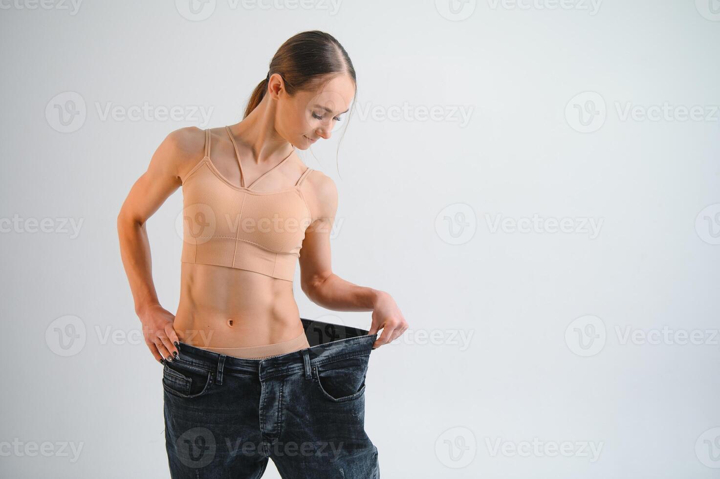 Joyful slim girl showing result of diet photo