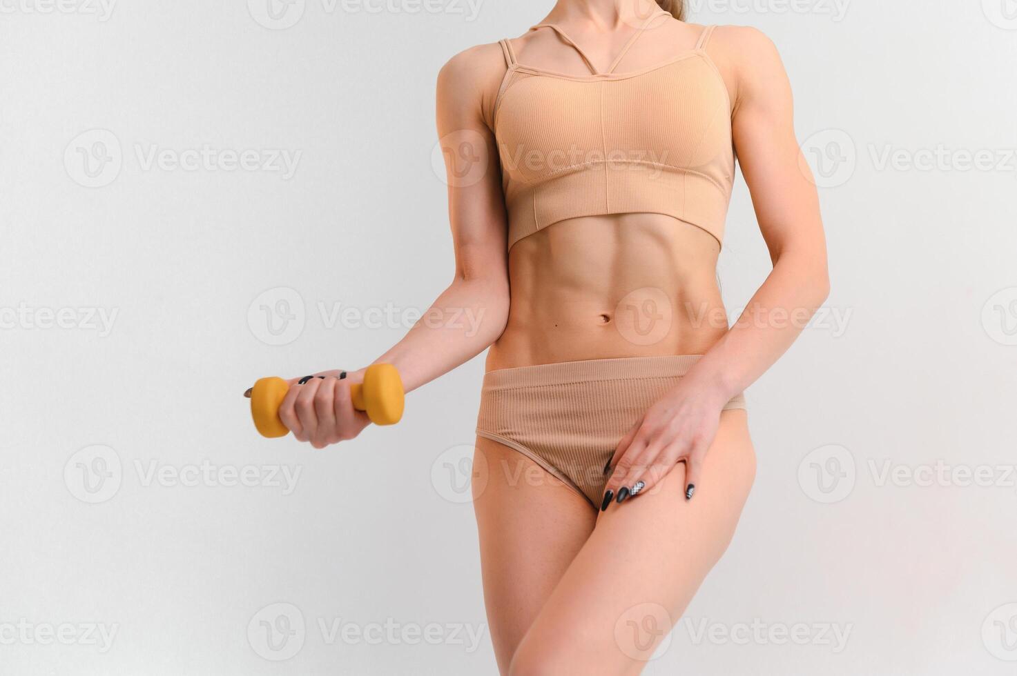 Sporty woman training with dumbbells. photo