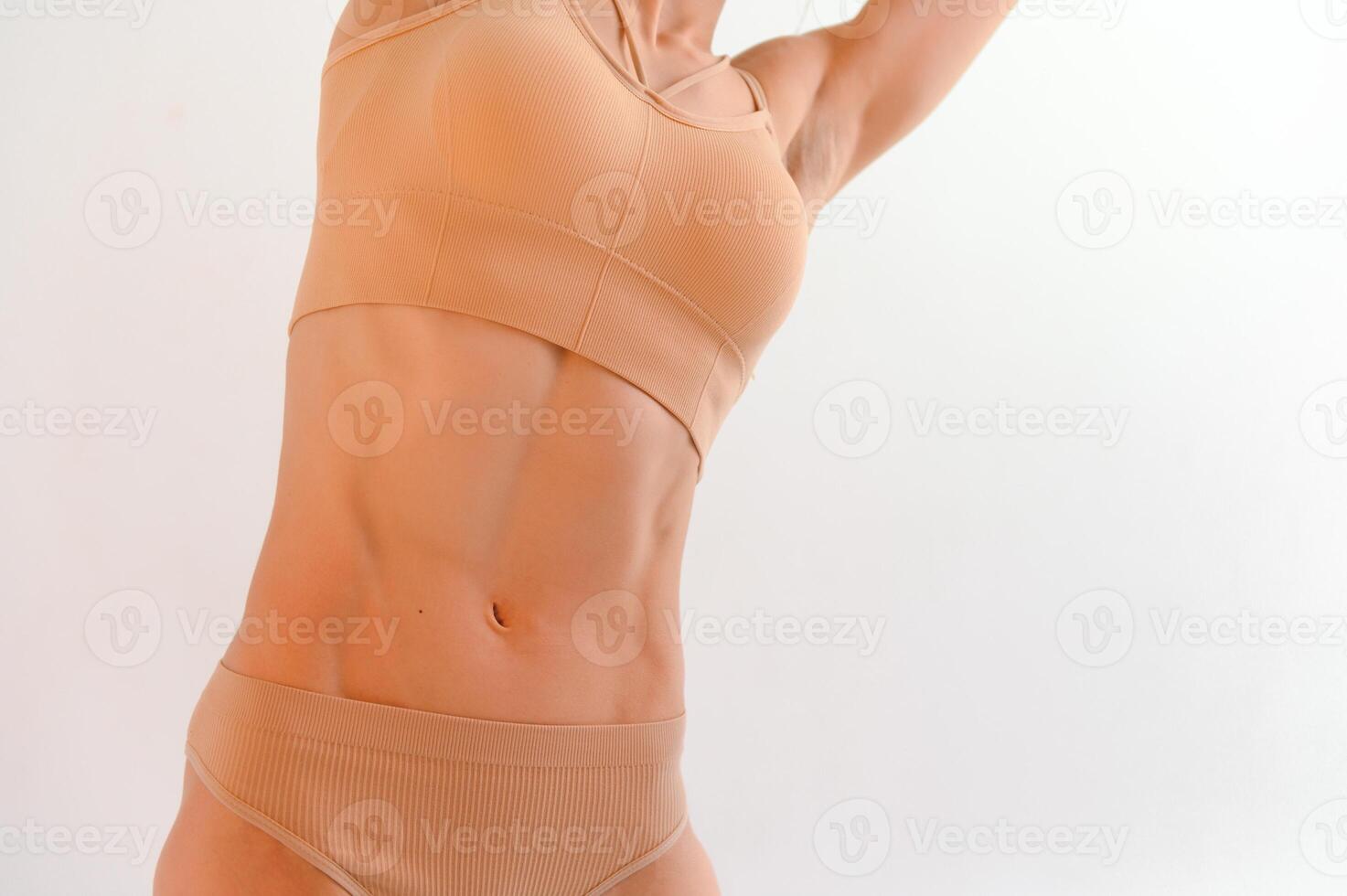 The body of a young athletic girl isolated on a white background photo