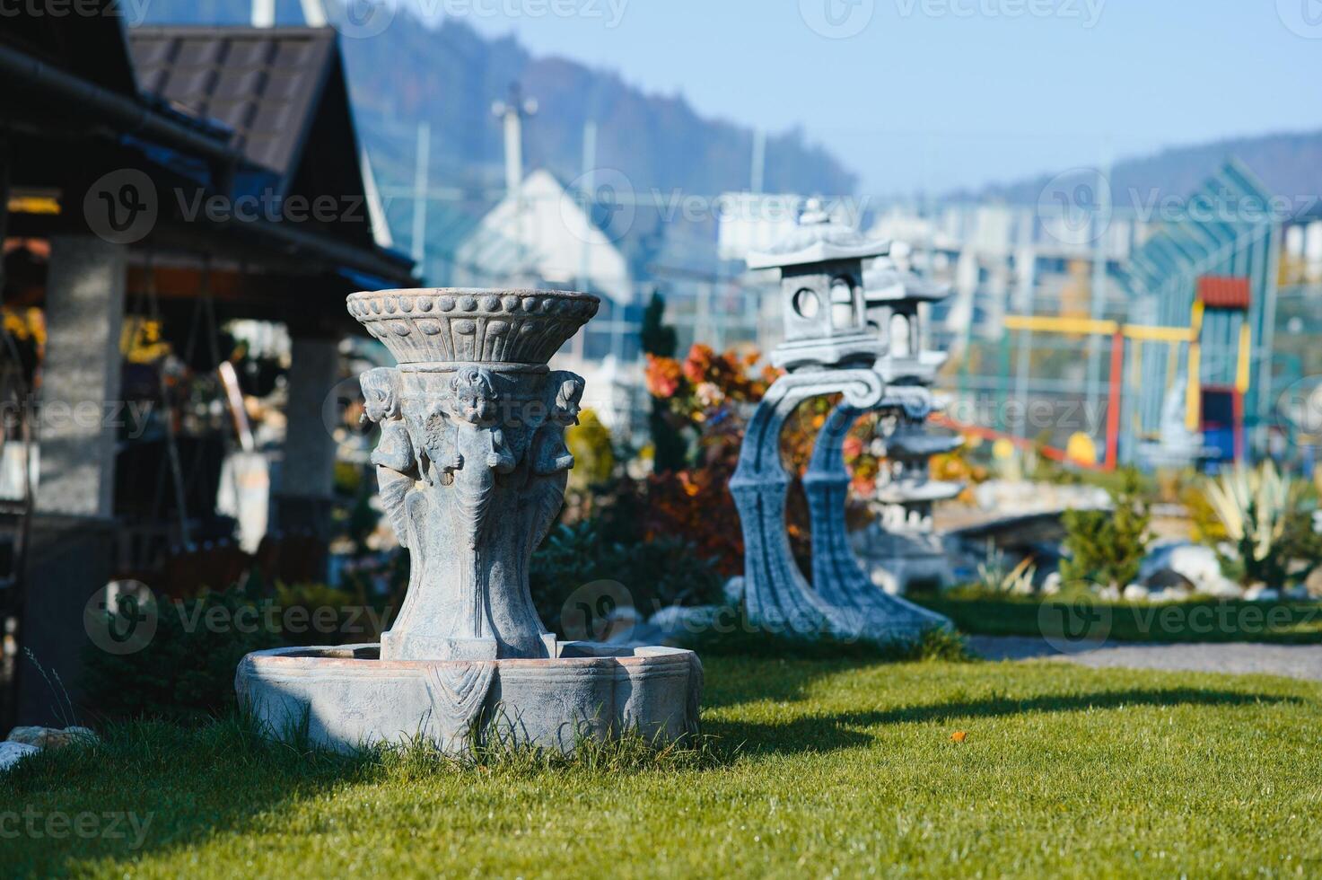 Fountain in the park garden. Water flows from the fountain. photo