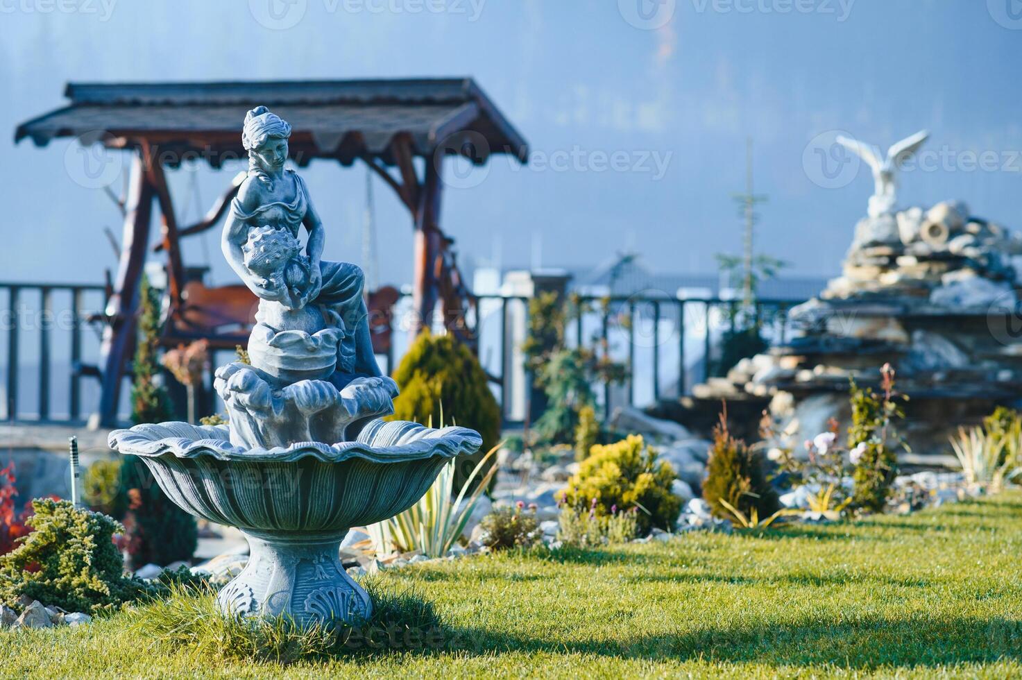 Fountain in the park garden. Water flows from the fountain. photo