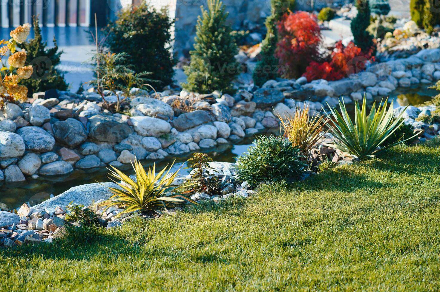 Backyard Garden Modern Design Landscaping. Landscaped Back Yard. Decorative Garden With Pathway Or Walkway From Stone And Rocks Or Gravel. Back Yard Or Park Lawn With Stony Natural landscaping. photo