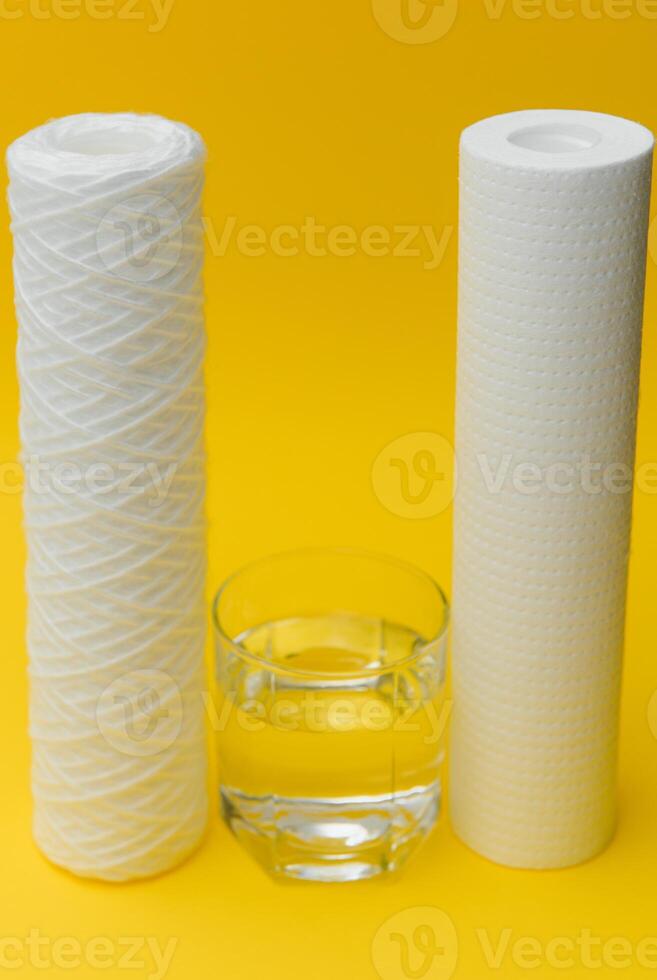Cartridges for water treatment systems on yellow background. photo