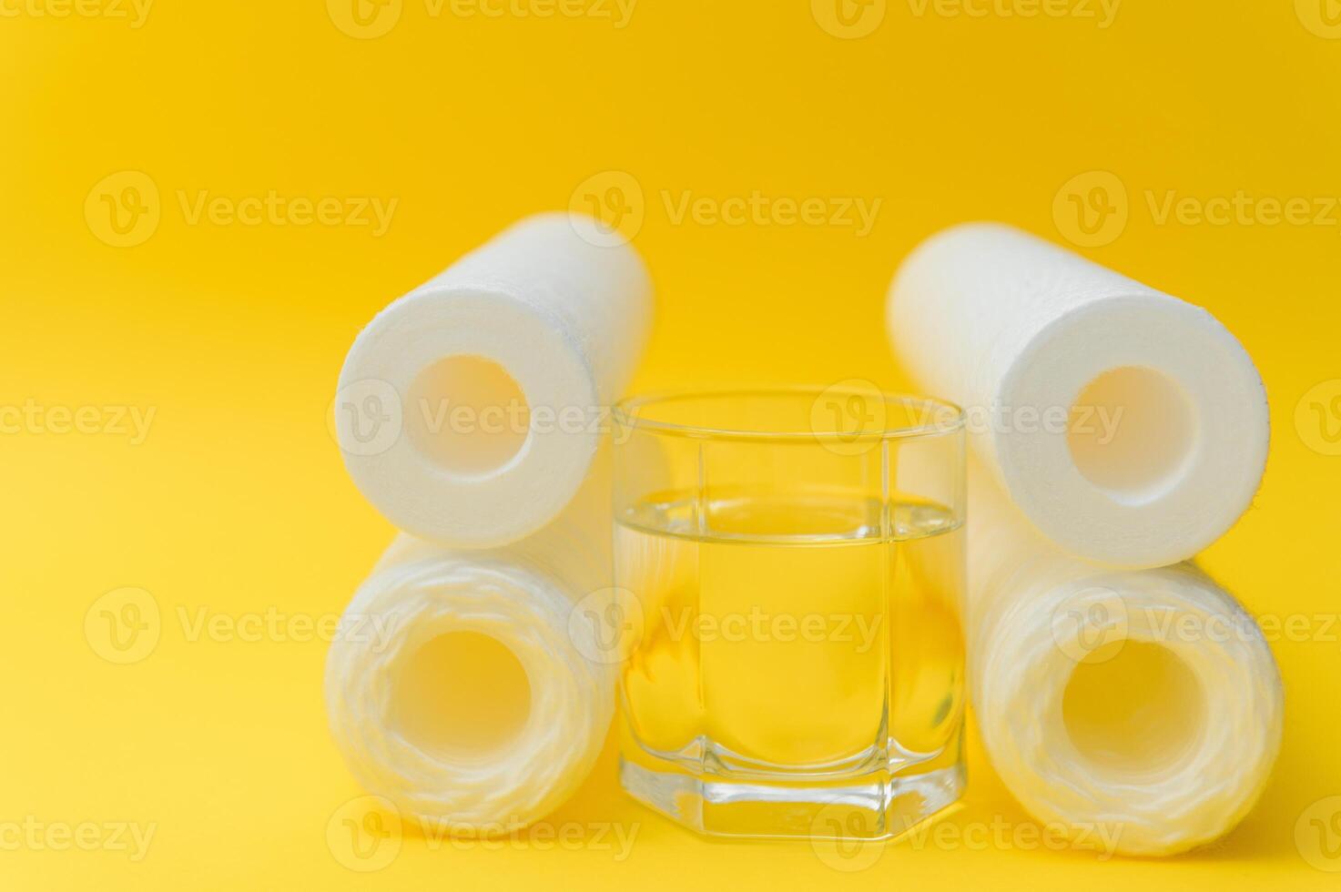 cartridges for water purification on a yellow background. Concept of clean water at home photo