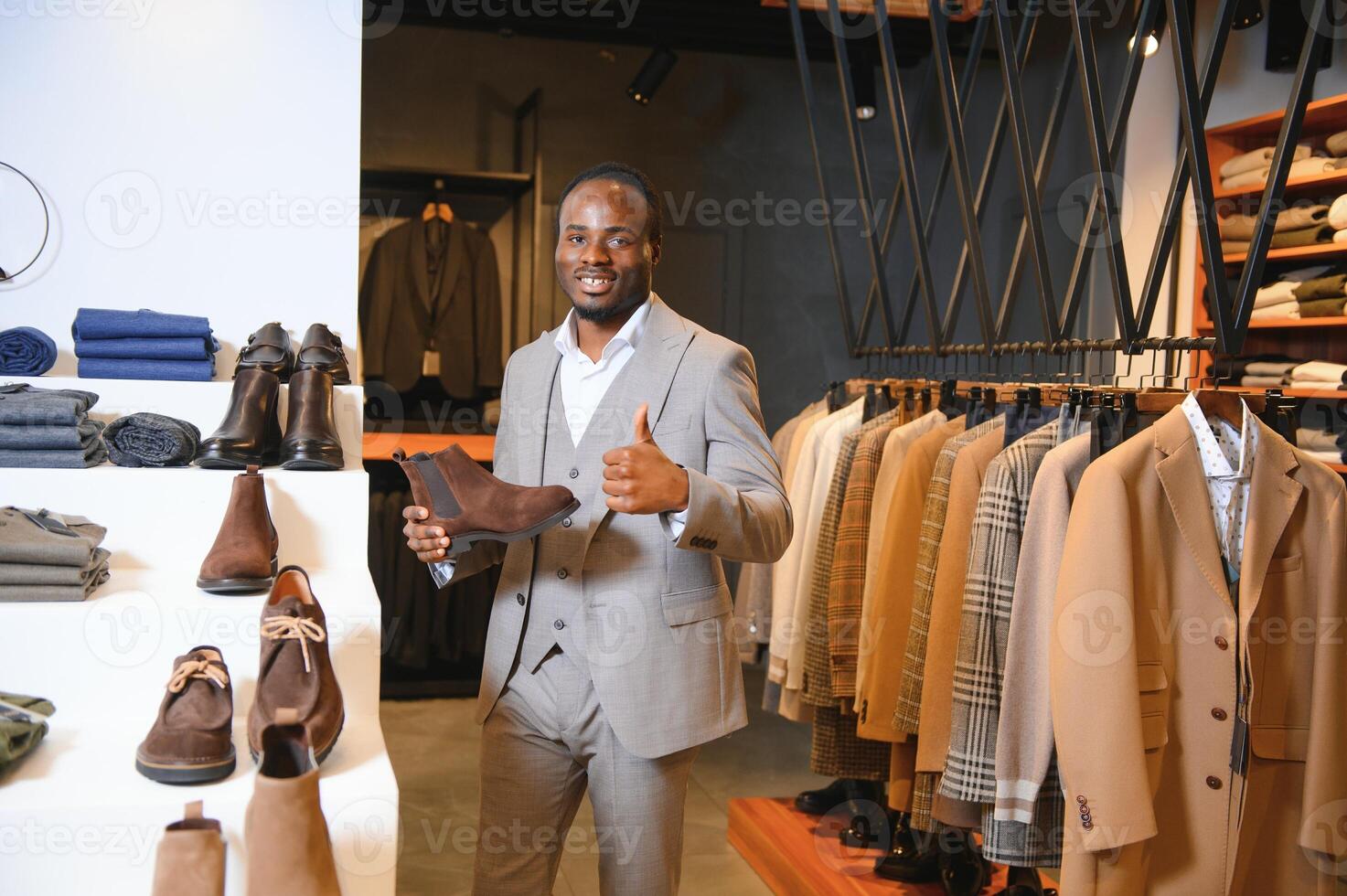 Young handsome man choosing shoes at a shop photo