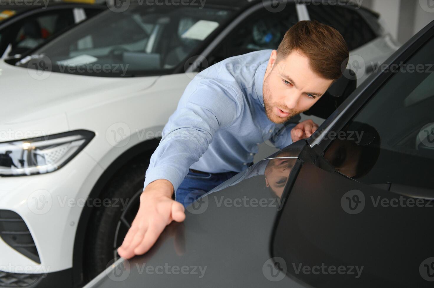 Man adult customer male buyer client chooses auto wants to buy new automobile photo