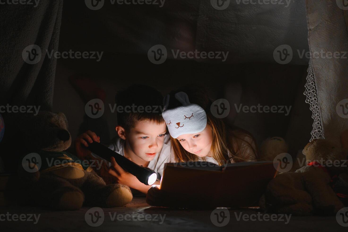 Little children reading bedtime story at home. photo