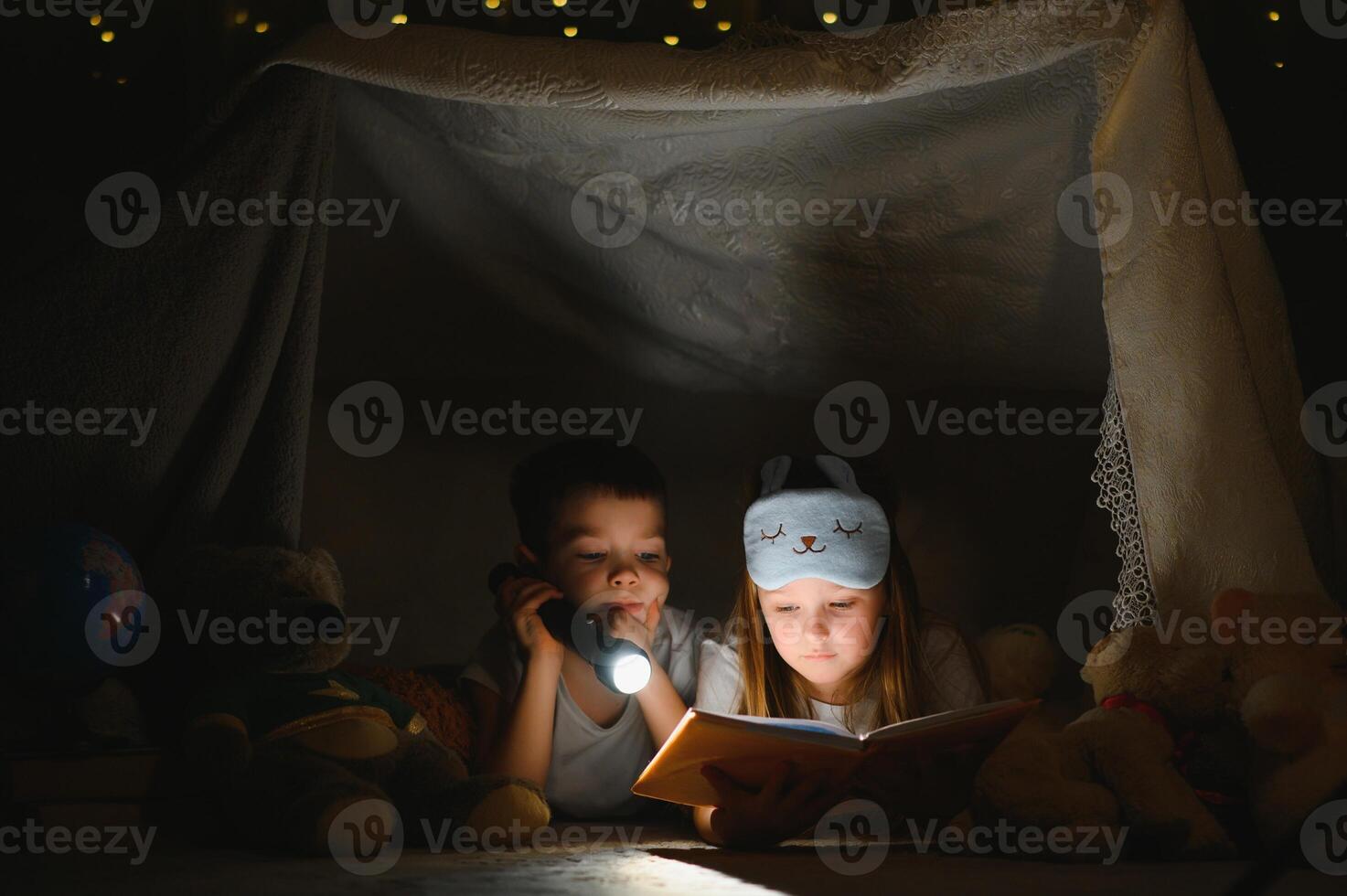 Little children reading bedtime story at home. photo