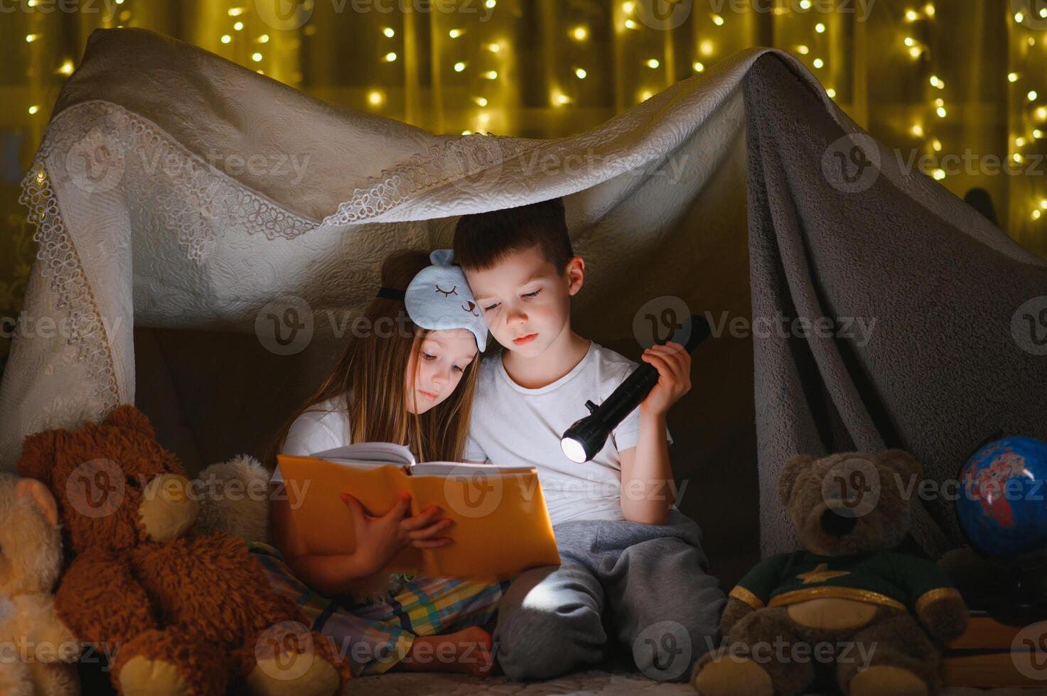 Little children reading bedtime story at home. photo