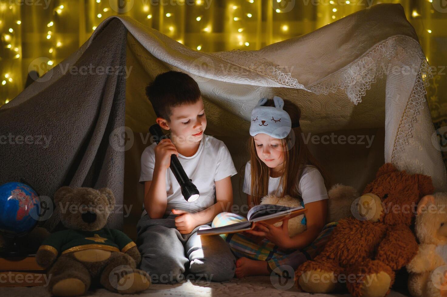Little children reading bedtime story at home photo