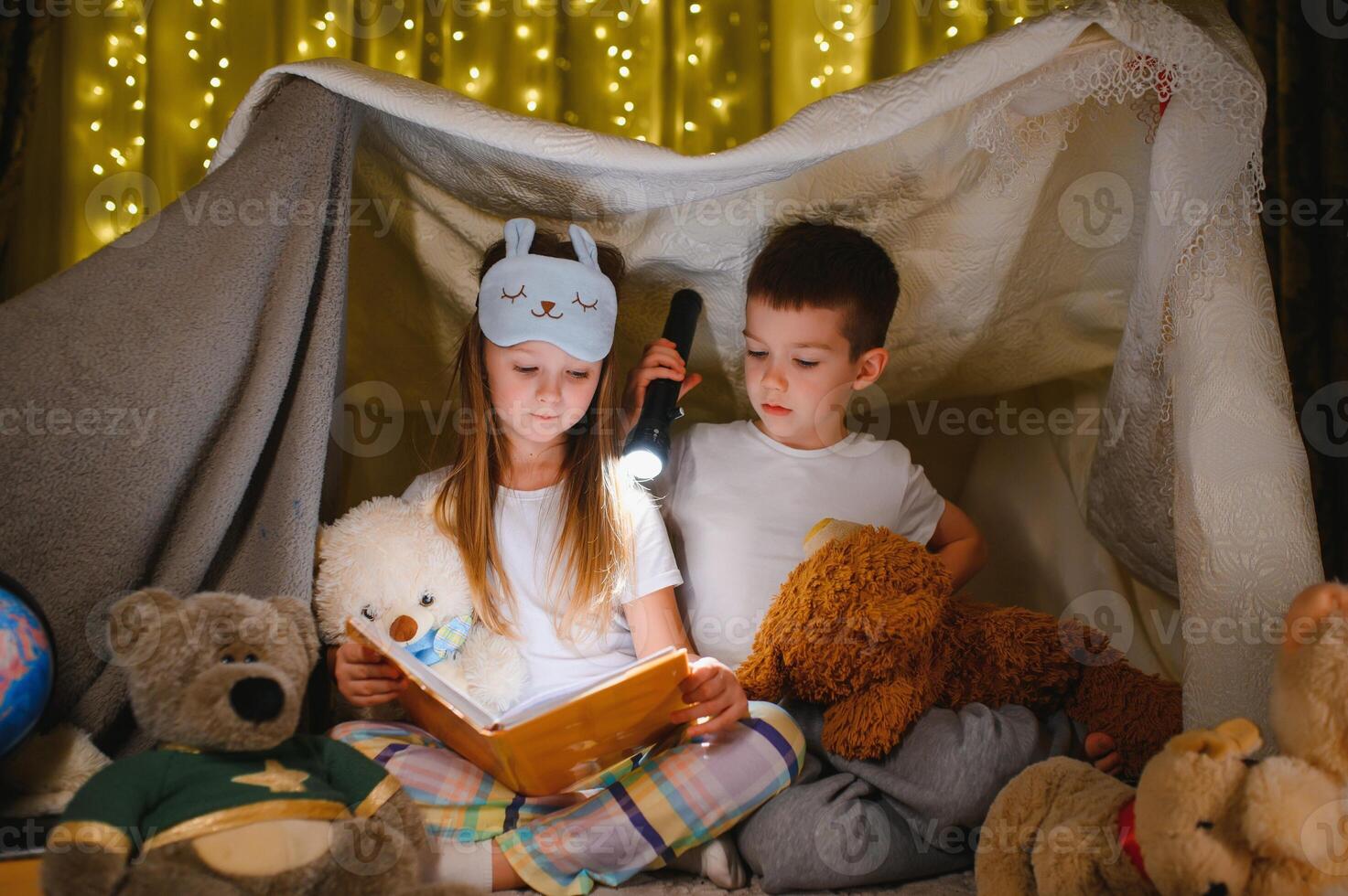 Little children reading bedtime story at home. photo