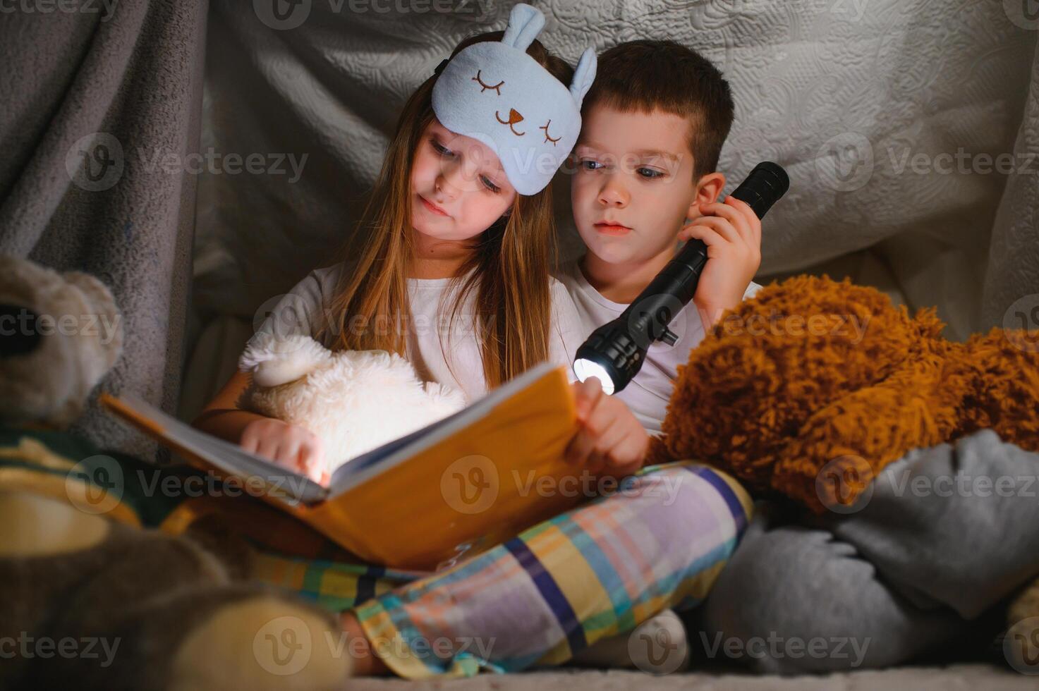 Little children reading bedtime story at home. photo