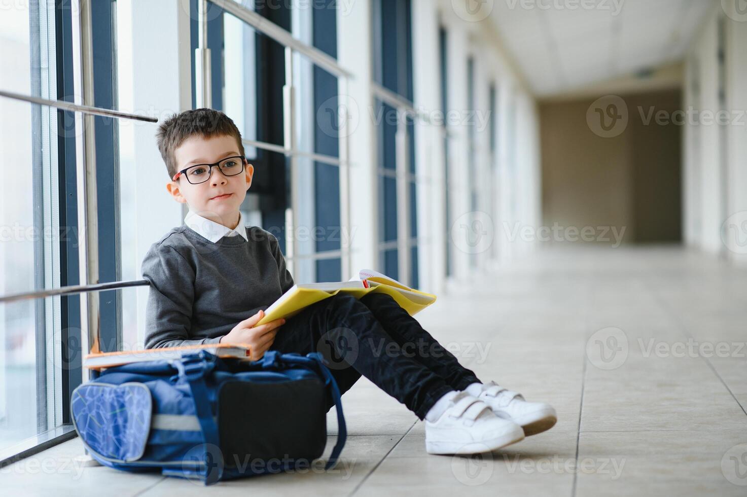Portrait of cute school boy with backpack. Schoolboy with a backpack at school. Back to school. photo