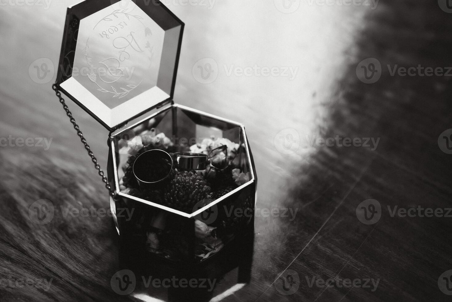 Elegant wedding rings for the bride and groom on a black background with highlights, macro, selective focus. photo