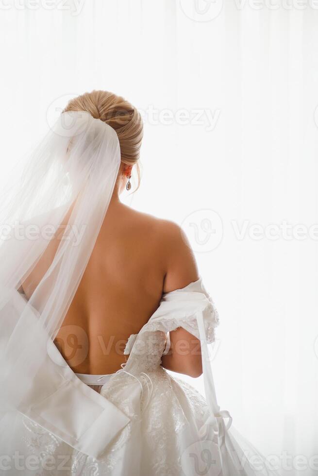 Bride dressing wedding gown. morning bride. photo