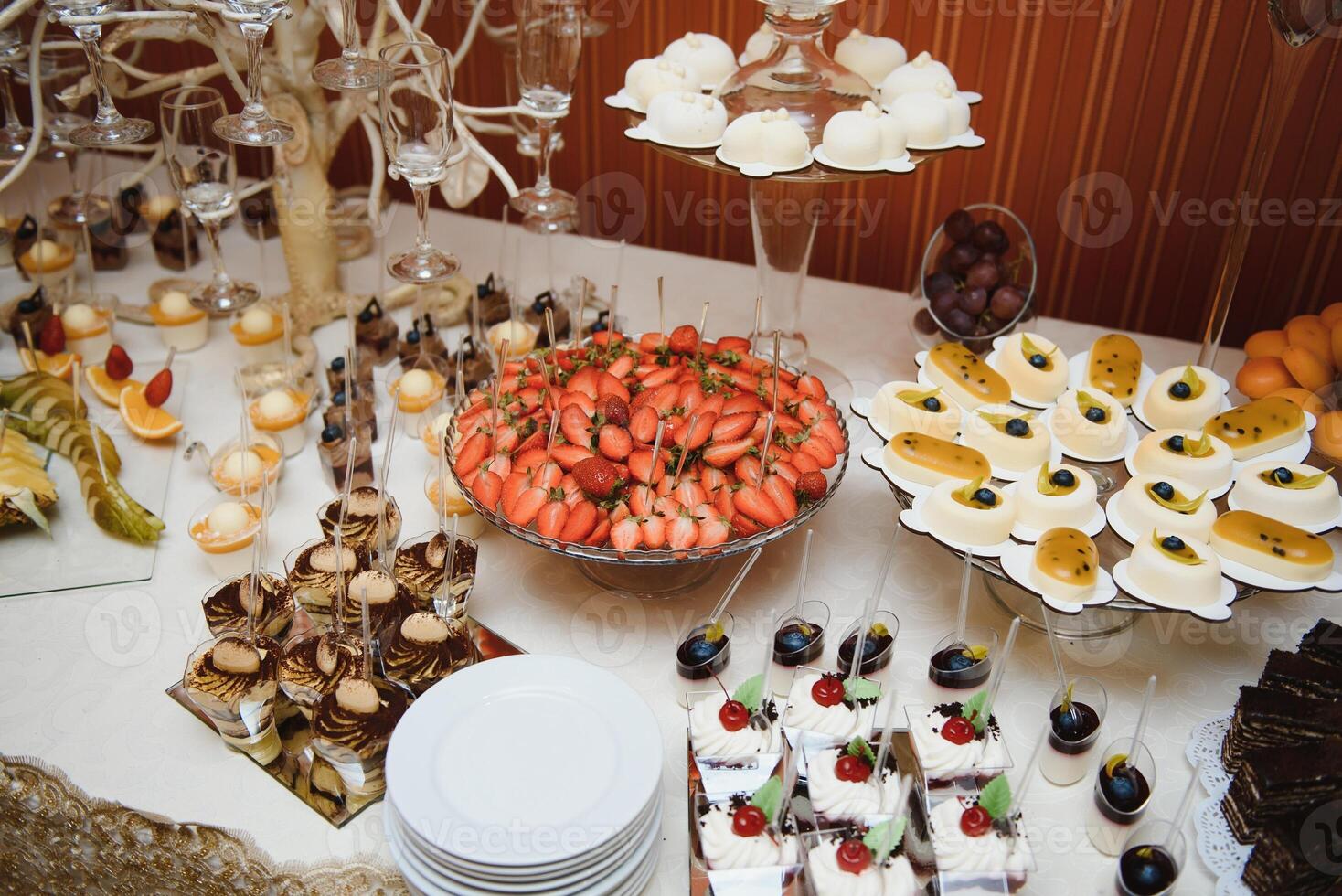 various dessert with fresh fruit on buffet line, sweet. photo