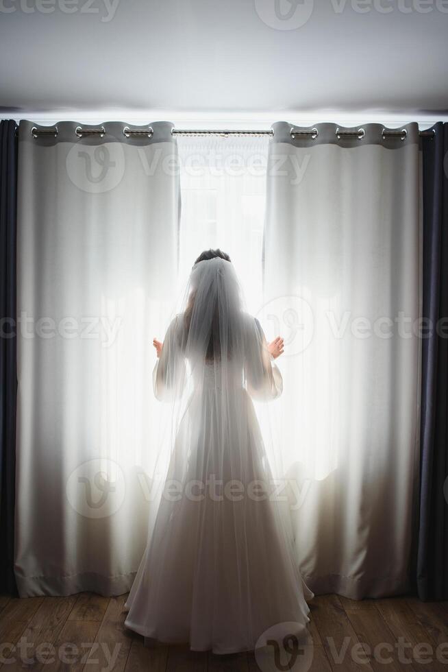 Bride dressing wedding gown. morning bride. photo