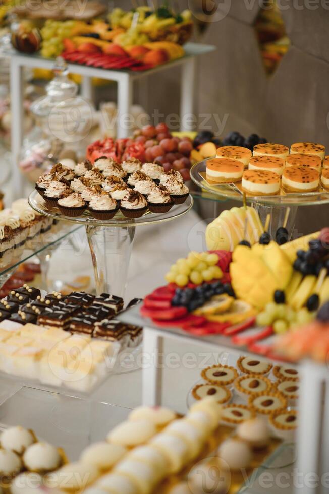 various dessert with fresh fruit on buffet line, sweet. photo