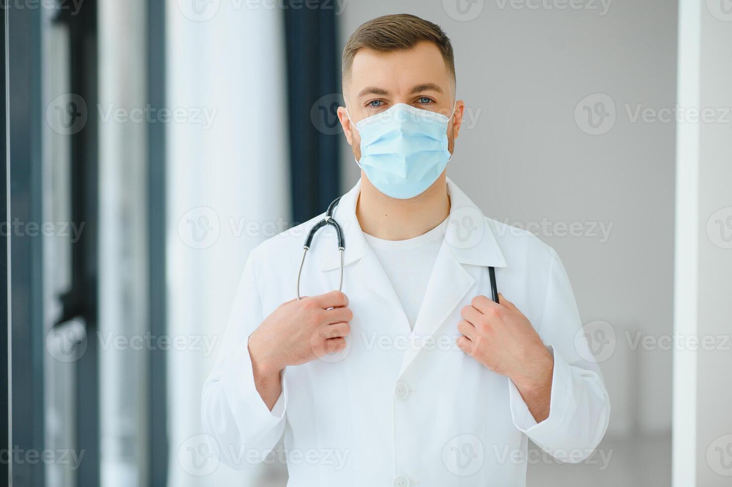 doctor man puts on a protective mask photo