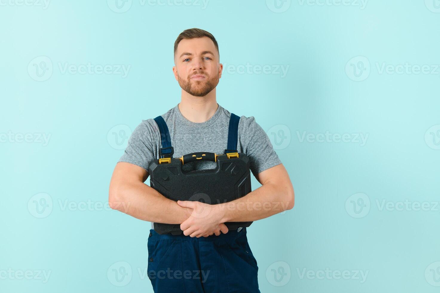 Portrait of a friendly worker. Isolated on blue photo