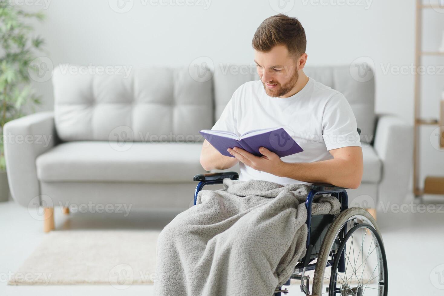 Person with a disability reading a book at home photo