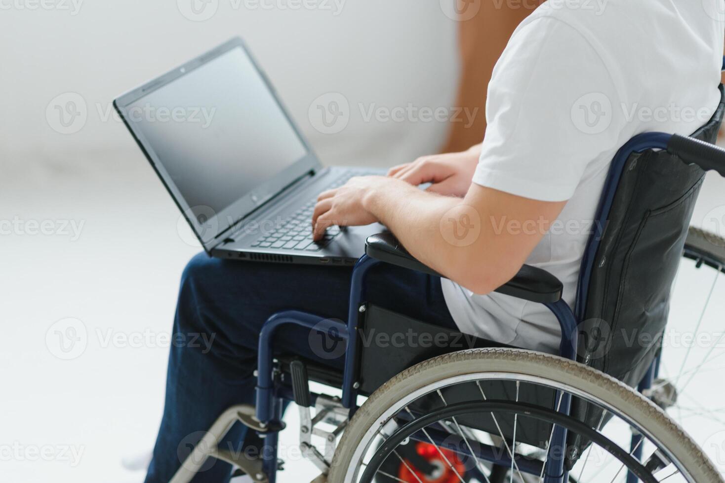 Person with a disability working on laptop in living room. photo