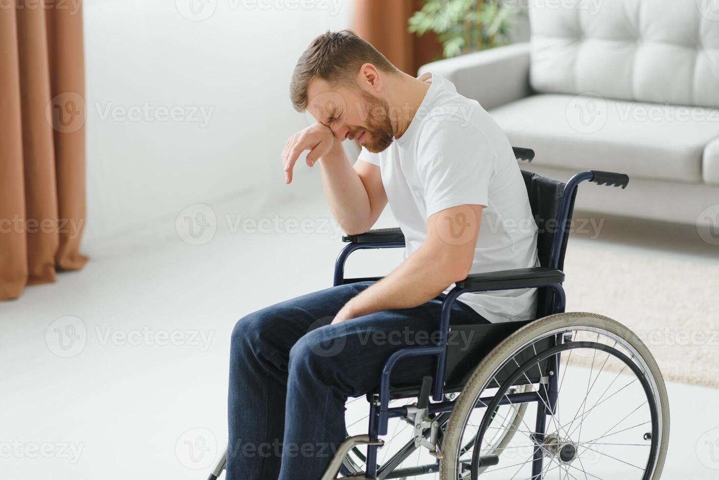 Disabled young man suffering at home photo