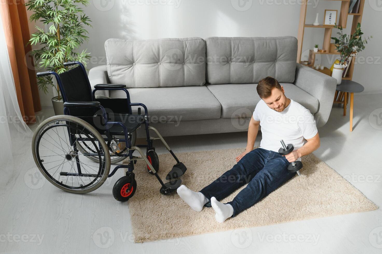 Man Disabled. Sports for Disabled. Male in Wheelchair with Dumbbells in Hands. Man with Dumbbells in Hands. Father Disabled Do Spotting. Sport at Apartment. Health Concept. Healthy Lifestyle. photo