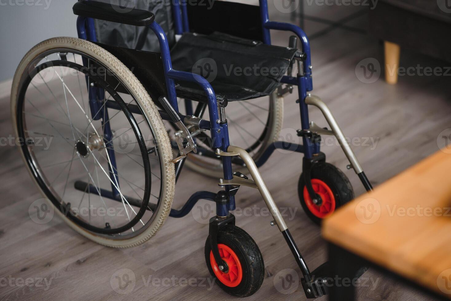 Empty wheelchair in black with large wheels and manual controls on home background. Barrier-free area. Nobody. Apartment room. House. Medical equipment rental. Copy space. Disabled mobility. Banner photo