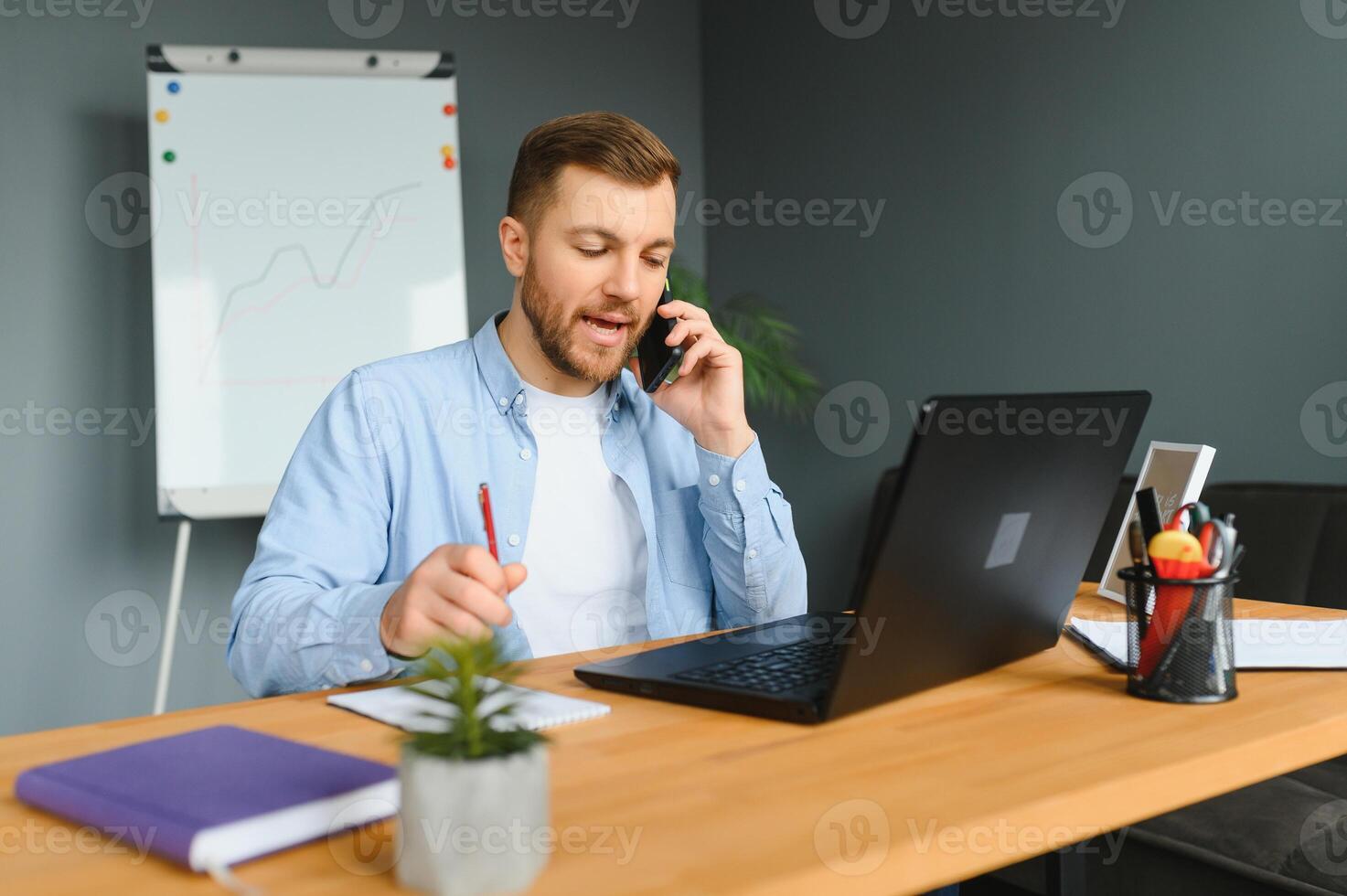 A man in a wheelchair is working in a office. The concept of work of people with disabilities. photo