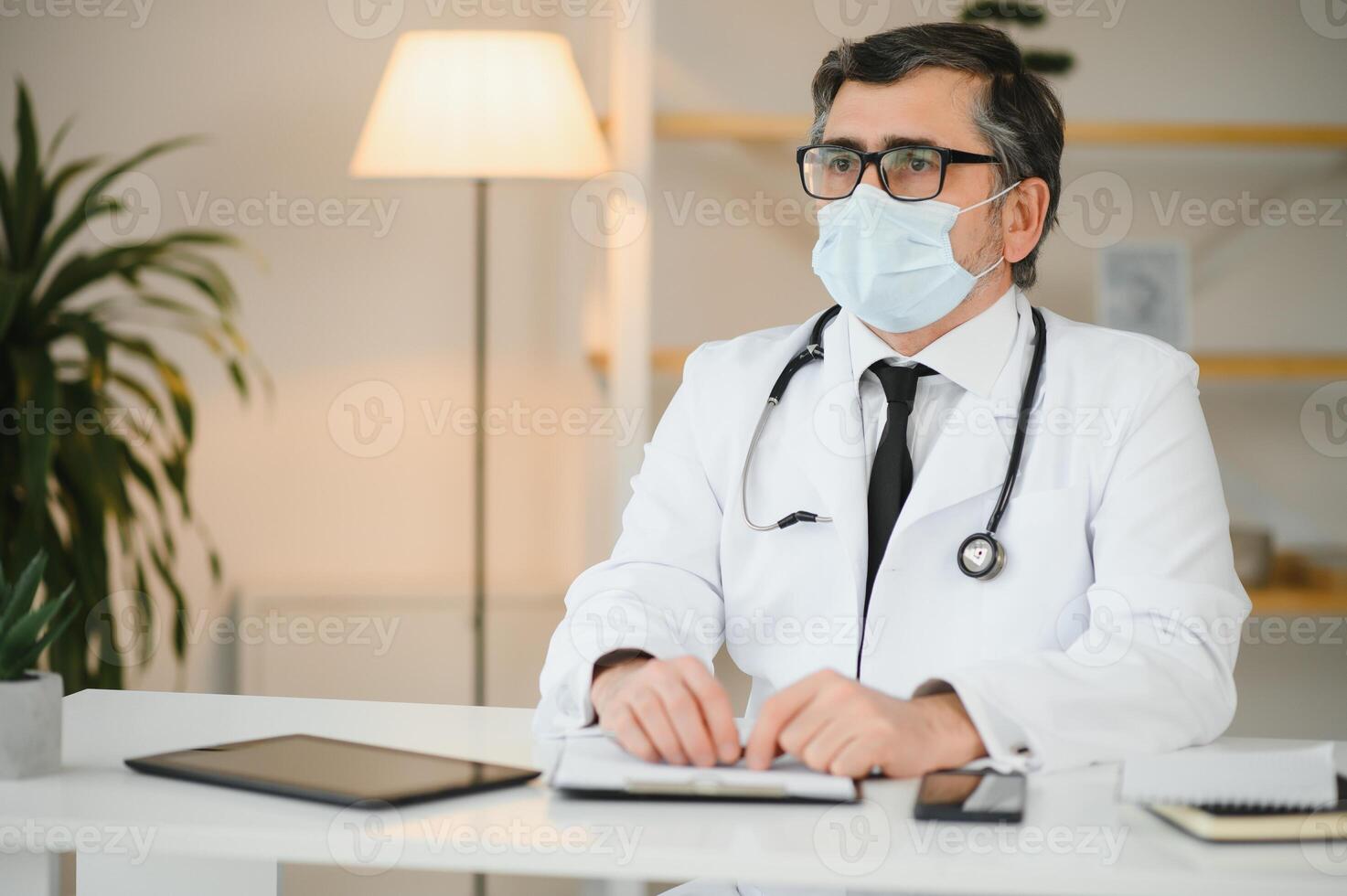 Close up of male doctor or scientist in protective facial mask. Medicine, healthcare and coronavirus pandemic concept photo