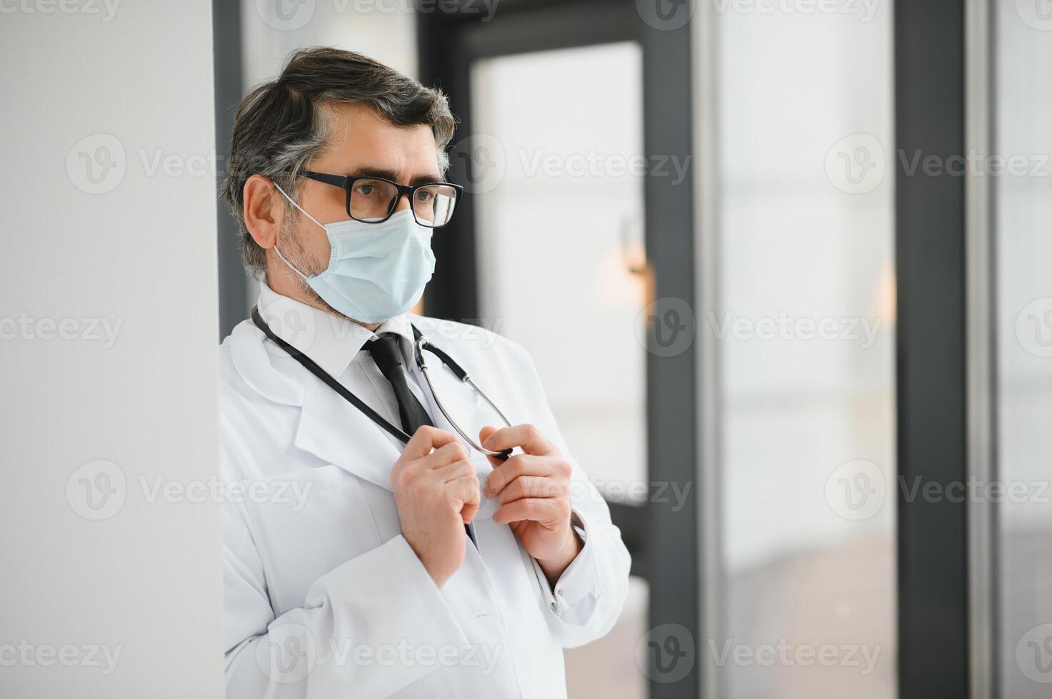 portrait of middle age doctor wearing protective mask. Corona virus concept. photo