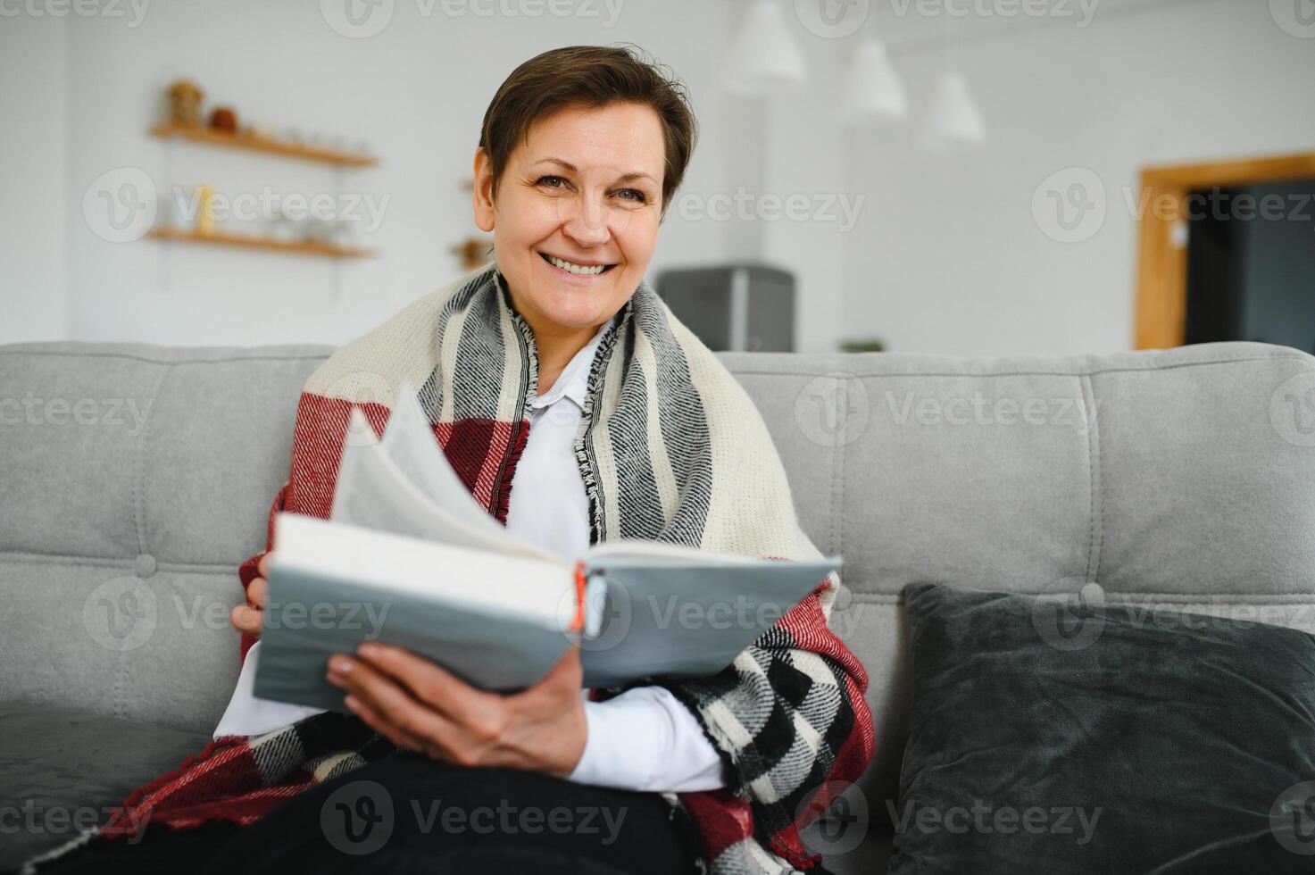 Portrait of senior woman reading book photo