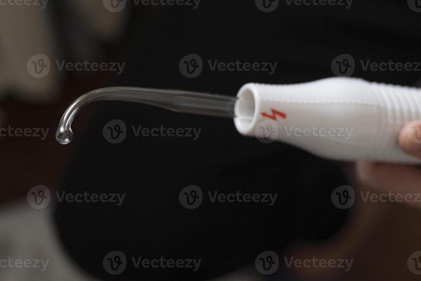 Close up shot of the high frequency comb tool for hair, scalp and skin treatment. Healthcare photo