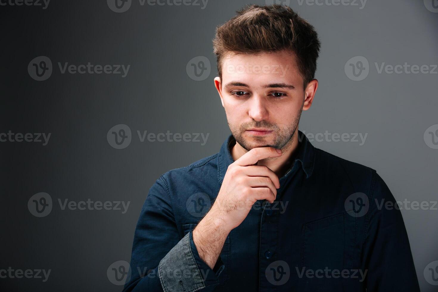 A Stylish Man in a Black Shirt Posing for a Picture photo