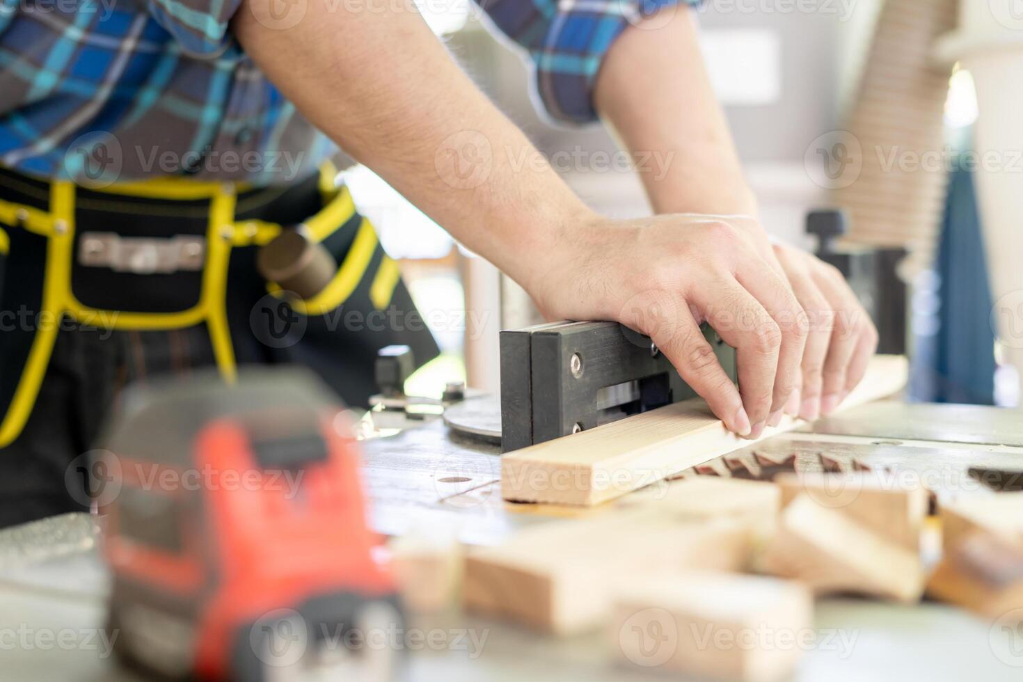 man owner a small furniture business is preparing wood for production. carpenter male is adjust wood to the desired size. architect, designer, Built-in, professional wood, craftsman, workshop. photo