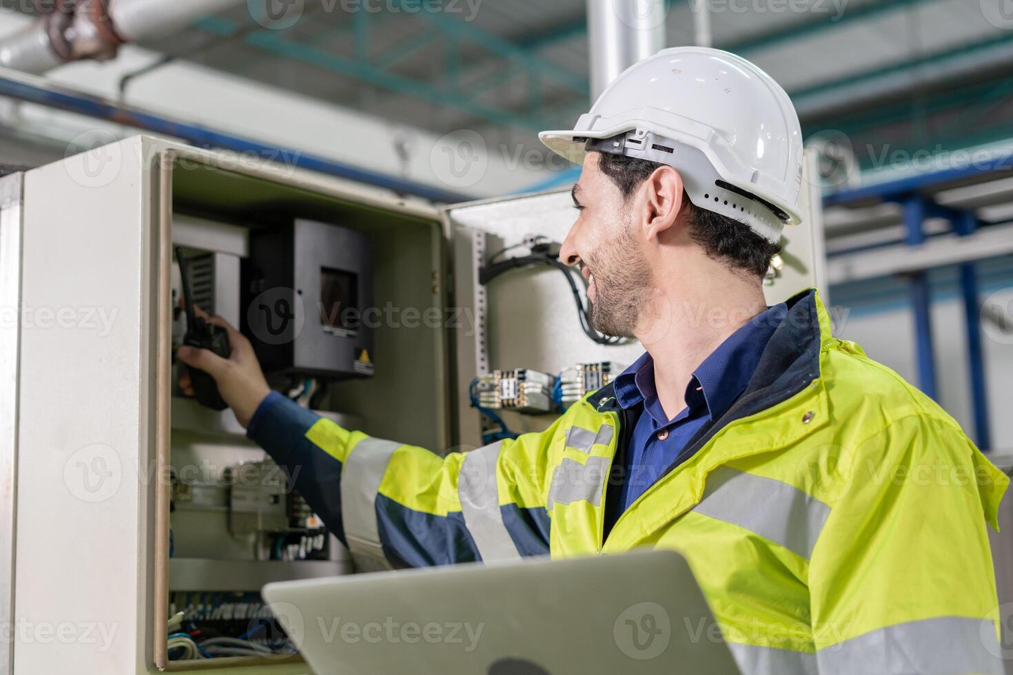 Mechanic or maintenance or electrical engineer checking main electrical control systems industrial plant. Utility fore man daily check power systems in process. Main Distribution Board, Switchboards photo