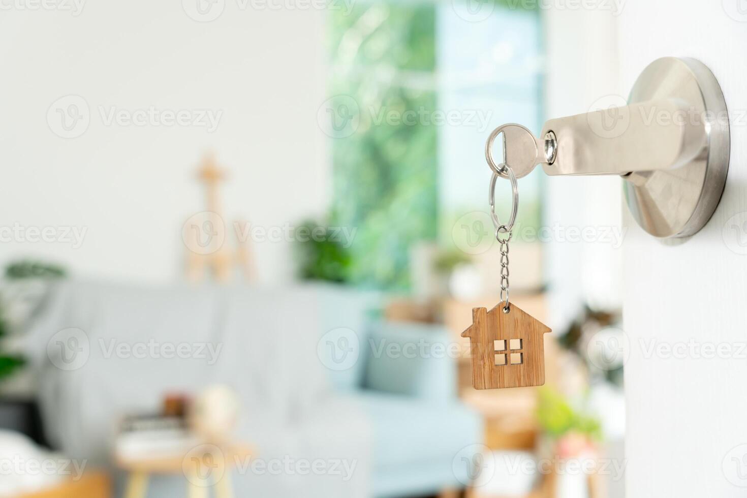 Moving house, relocation. The key was inserted into the door of the new house, inside the room was a cardboard box containing personal belongings and furniture. move in the apartment, banner photo