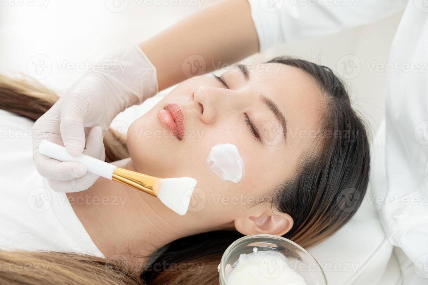 Beautiful woman receive spa and treatment skin of face. face of a healthy woman apply cream. Advertisement for skin cream, anti-wrinkle, baby face, whitening, moisturizer, tighten pores serum photo