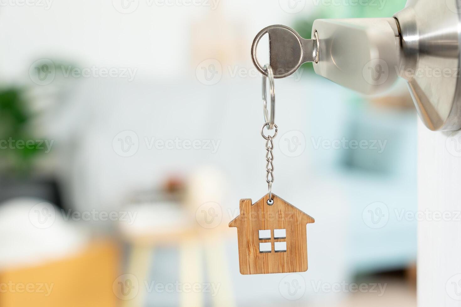 Moving house, relocation. The key was inserted into the door of the new house, inside the room was a cardboard box containing personal belongings and furniture. move in the apartment or condominium photo