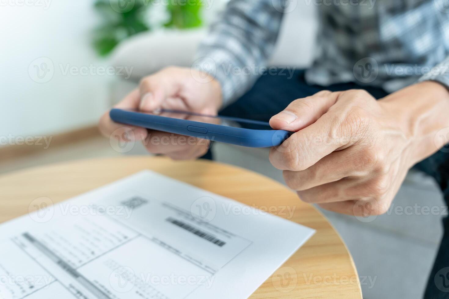 business man use phone to scan barcode or QR codes to pay credit card bill after receiving document invoice online. payment, receive, paying electricity, digital payments without money, technology photo
